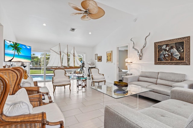 living room featuring light tile patterned floors, vaulted ceiling, and ceiling fan