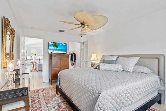 tiled bedroom with ceiling fan