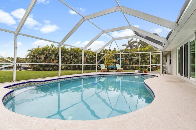 view of swimming pool featuring a patio area, a lanai, and a yard