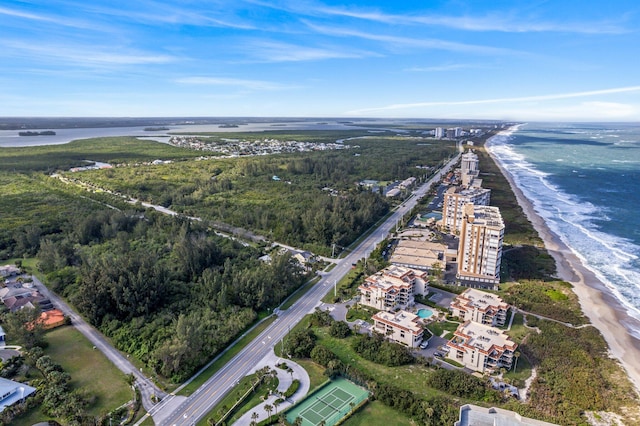 birds eye view of property featuring a water view and a beach view