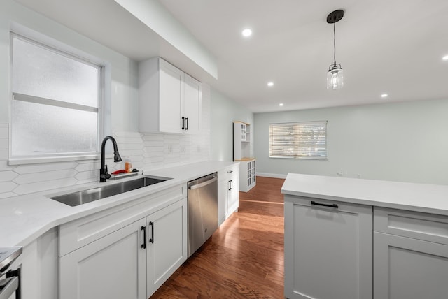 kitchen featuring decorative backsplash, white cabinets, sink, dishwasher, and dark hardwood / wood-style floors