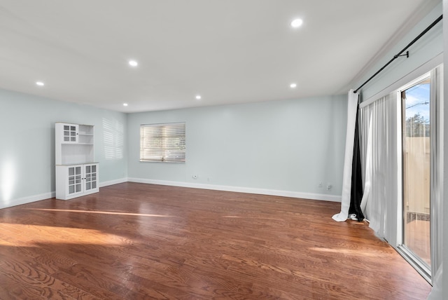 unfurnished living room featuring dark wood-type flooring