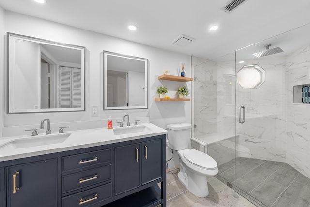 bathroom featuring tile patterned floors, vanity, toilet, and a shower with shower door