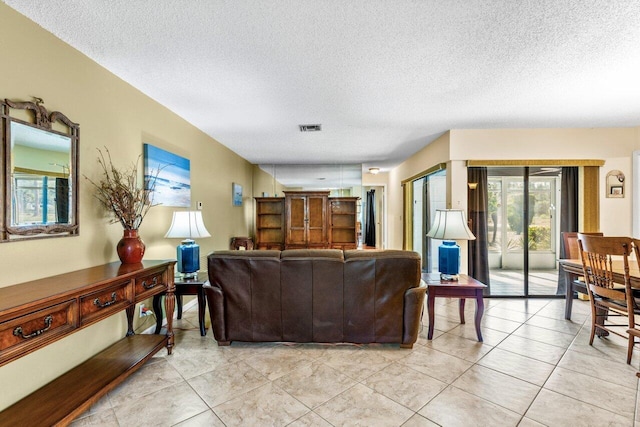 tiled living room with a textured ceiling