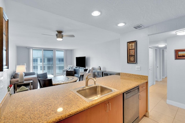 kitchen with sink, stainless steel dishwasher, ceiling fan, light tile patterned floors, and a textured ceiling