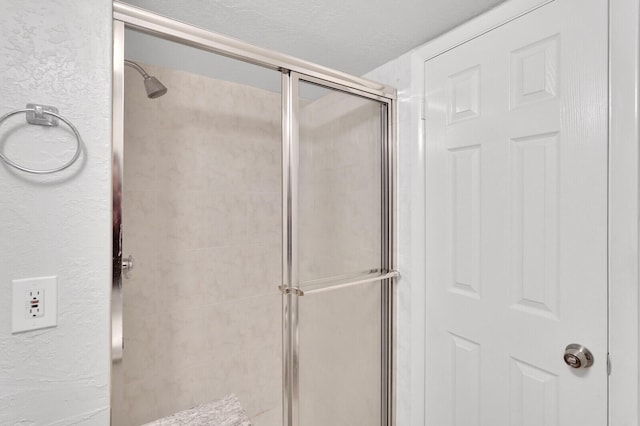 bathroom with a shower with shower door