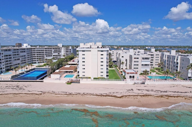 bird's eye view with a water view and a beach view