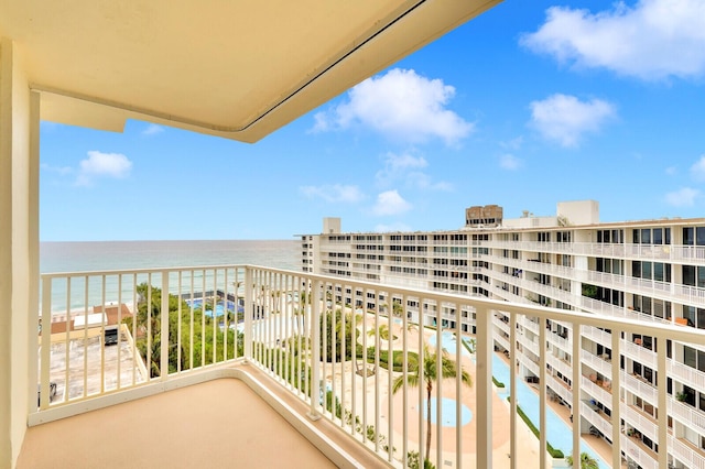 balcony featuring a beach view and a water view