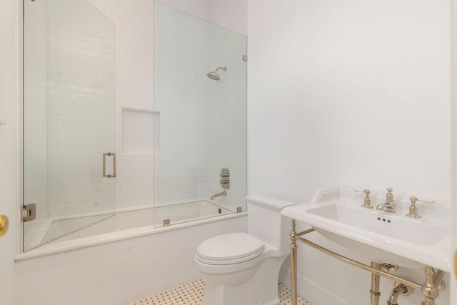 234 Miramar Way, West Palm Beach, FL 33405 - full bath with toilet, enclosed tub / shower combo, baseboards, and a sink