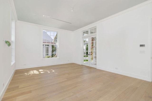 234 Miramar Way, West Palm Beach, FL 33405 - empty room with ornamental molding, french doors, plenty of natural light, light wood-style floors, and baseboards