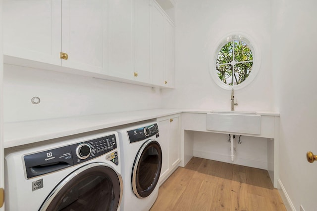 234 Miramar Way, West Palm Beach, FL 33405 - washroom with washer and dryer, light wood-style flooring, cabinet space, and baseboards