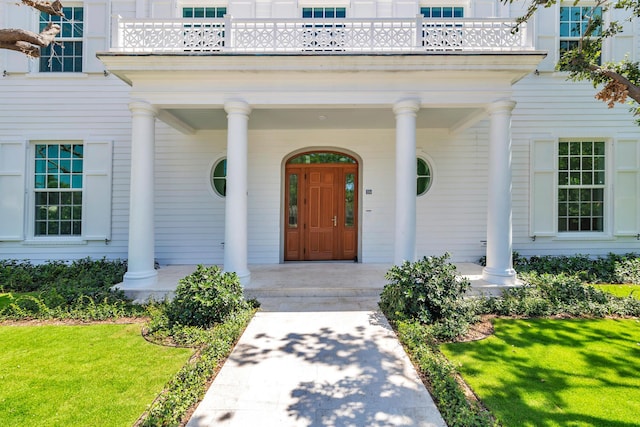 234 Miramar Way, West Palm Beach, FL 33405 - view of exterior entry featuring a porch and a yard