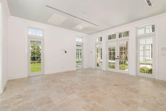 234 Miramar Way, West Palm Beach, FL 33405 - empty room with light stone finish floors, french doors, baseboards, and crown molding