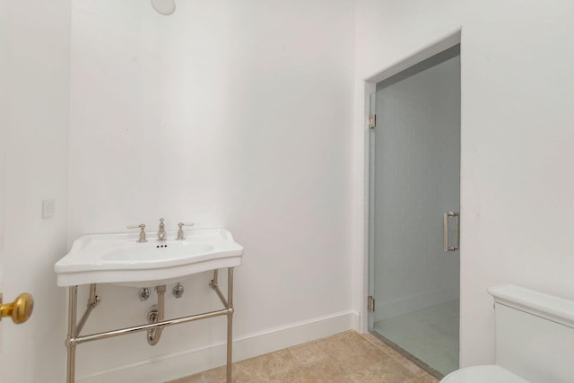 234 Miramar Way, West Palm Beach, FL 33405 - bathroom with toilet, a stall shower, and baseboards