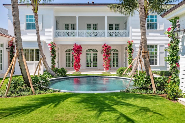 234 Miramar Way, West Palm Beach, FL 33405 - back of property with french doors, a yard, an outdoor pool, and a balcony