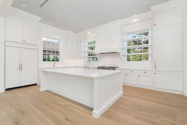 234 Miramar Way, West Palm Beach, FL 33405 - kitchen featuring light wood-type flooring, white cabinets, open shelves, light countertops, and ornamental molding