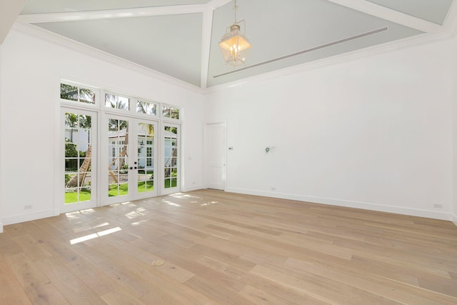 234 Miramar Way, West Palm Beach, FL 33405 - empty room with french doors, high vaulted ceiling, light wood finished floors, baseboards, and a chandelier