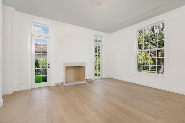 234 Miramar Way, West Palm Beach, FL 33405 - unfurnished living room with light wood-style floors, a fireplace with flush hearth, plenty of natural light, and ornamental molding
