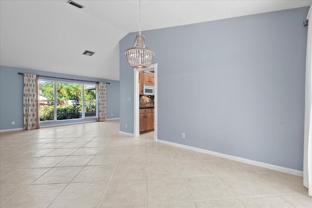 unfurnished room with light tile patterned floors, high vaulted ceiling, and a notable chandelier