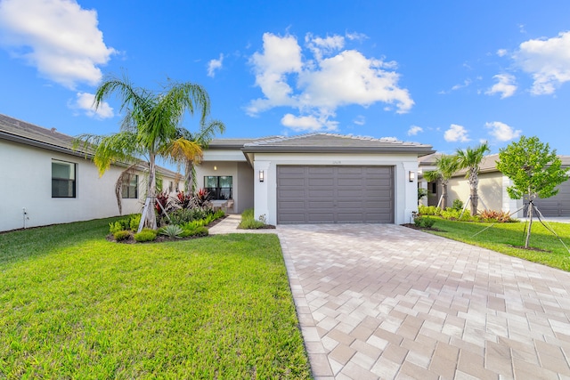 ranch-style home with a garage and a front yard