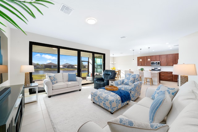 living room featuring an inviting chandelier and light tile patterned flooring