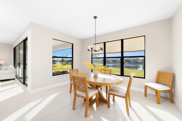 tiled dining room featuring a water view and a notable chandelier