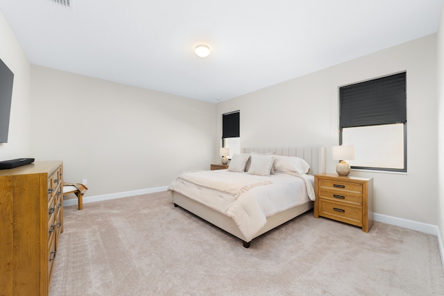 bedroom featuring light colored carpet