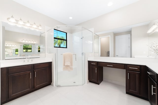 bathroom with vanity, a shower with shower door, and a wealth of natural light