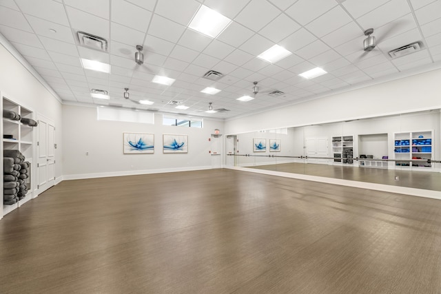 exercise area featuring a paneled ceiling