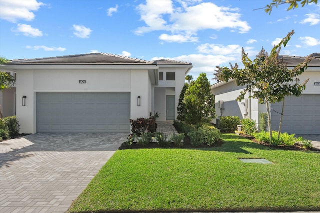 view of front of house with a front yard and a garage