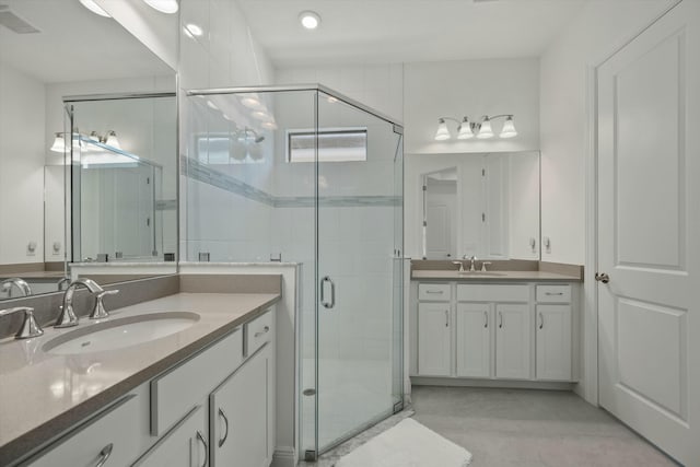 bathroom featuring vanity and an enclosed shower