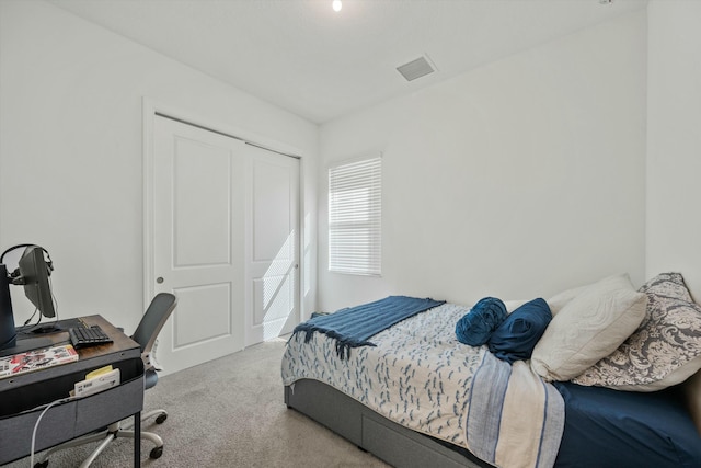 carpeted bedroom featuring a closet