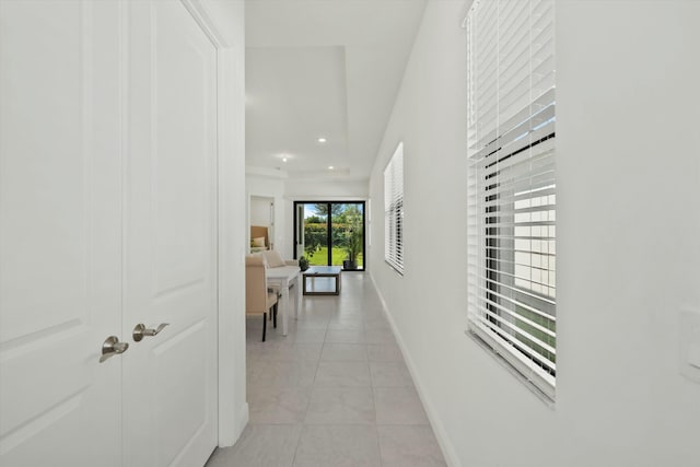 hall with light tile patterned floors