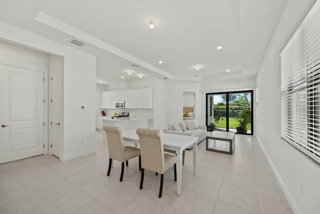 dining space featuring light tile patterned floors