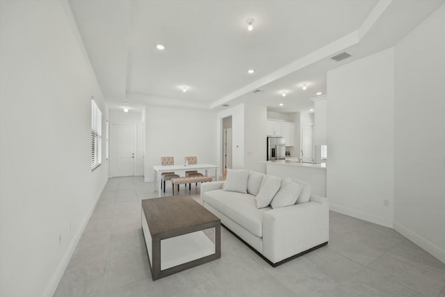 living room with a tray ceiling