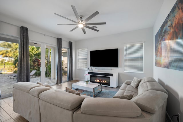 living room with ceiling fan and light hardwood / wood-style floors