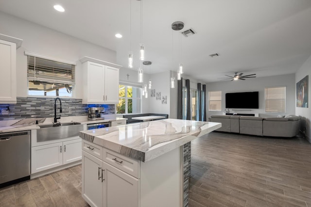 kitchen with white cabinets, dishwasher, and sink