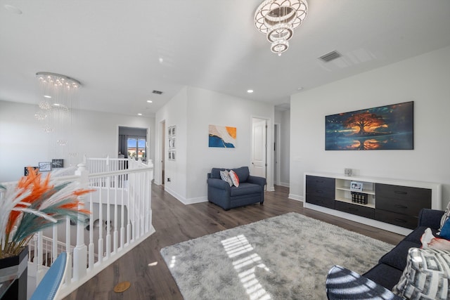 living room featuring dark wood-type flooring and an inviting chandelier