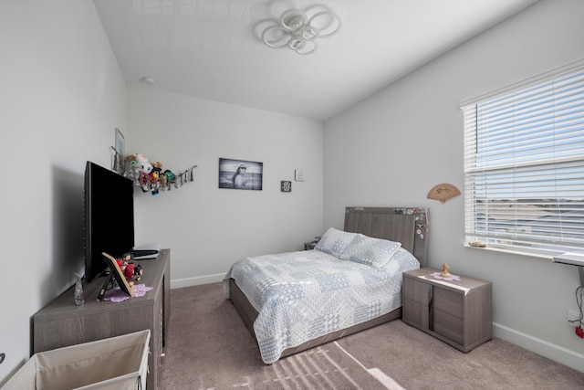 carpeted bedroom featuring multiple windows