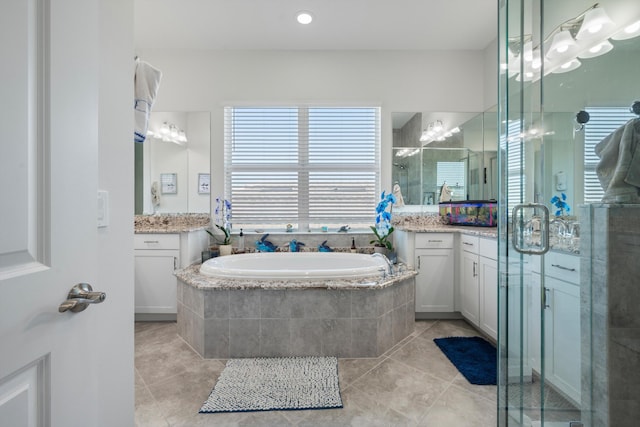 bathroom with tile patterned floors, vanity, and plus walk in shower