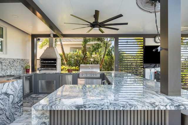 view of patio with area for grilling, ceiling fan, sink, and exterior kitchen