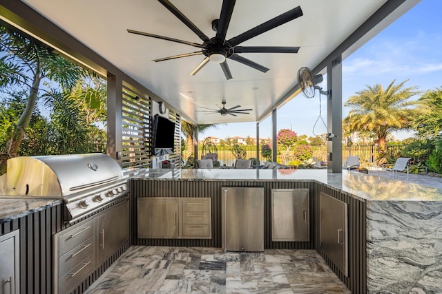 view of patio featuring area for grilling and ceiling fan