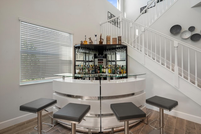 bar with hardwood / wood-style floors