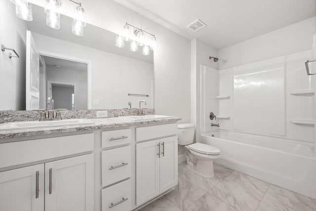 full bathroom featuring washtub / shower combination, vanity, and toilet