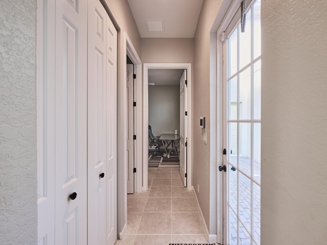 corridor with light tile patterned floors