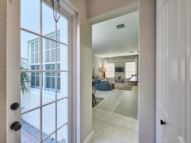 interior space with light tile patterned floors and a wealth of natural light