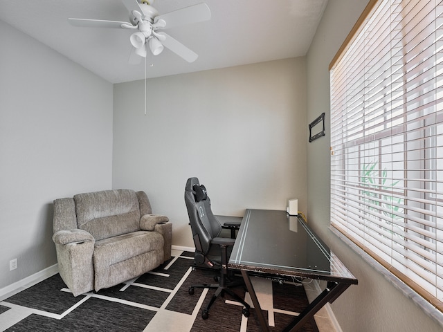 office featuring dark colored carpet and ceiling fan