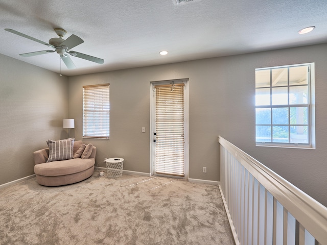 sitting room with light colored carpet and ceiling fan