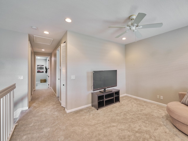 sitting room featuring light carpet and ceiling fan