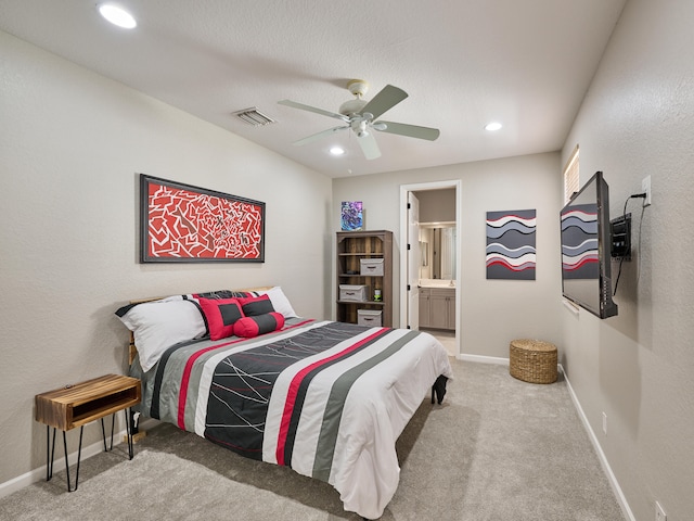 bedroom featuring ensuite bath, ceiling fan, and carpet